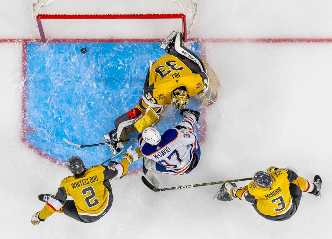 Edmonton Oilers center Connor McDavid (97) scores past Golden Knights goaltender Adin Hill (33) ...