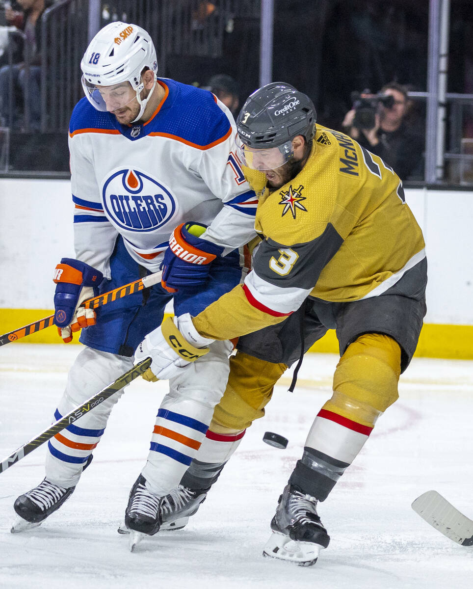 Edmonton Oilers left wing Zach Hyman (18) and Golden Knights defenseman Brayden McNabb (3) figh ...