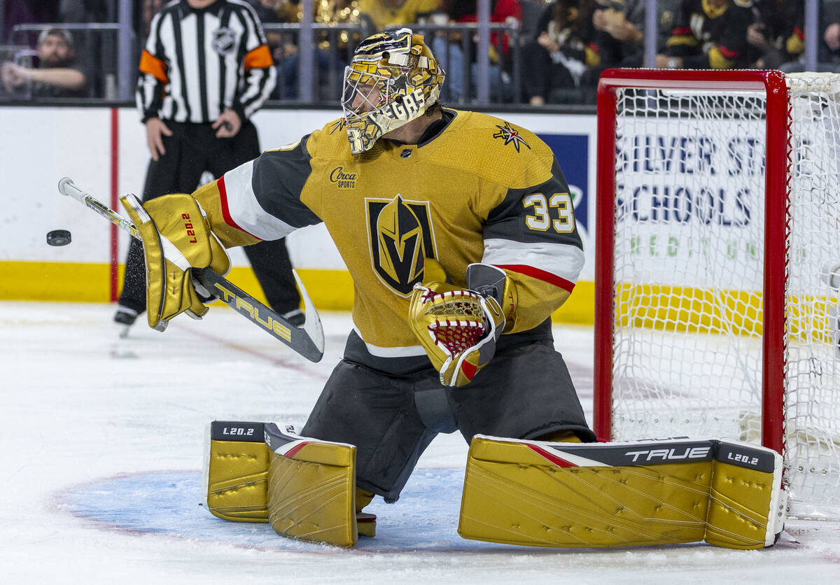 Golden Knights goaltender Adin Hill (33) deflects a Edmonton Oilers shot during the second peri ...