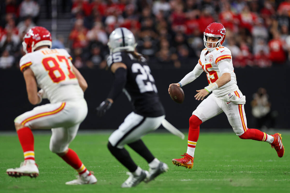 Kansas City Chiefs quarterback Patrick Mahomes (15) runs the ball as his teammate tight end Tra ...