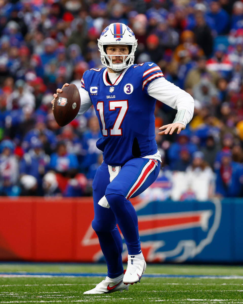 Buffalo Bills quarterback Josh Allen (17) runs the ball during the first half of an NFL footbal ...