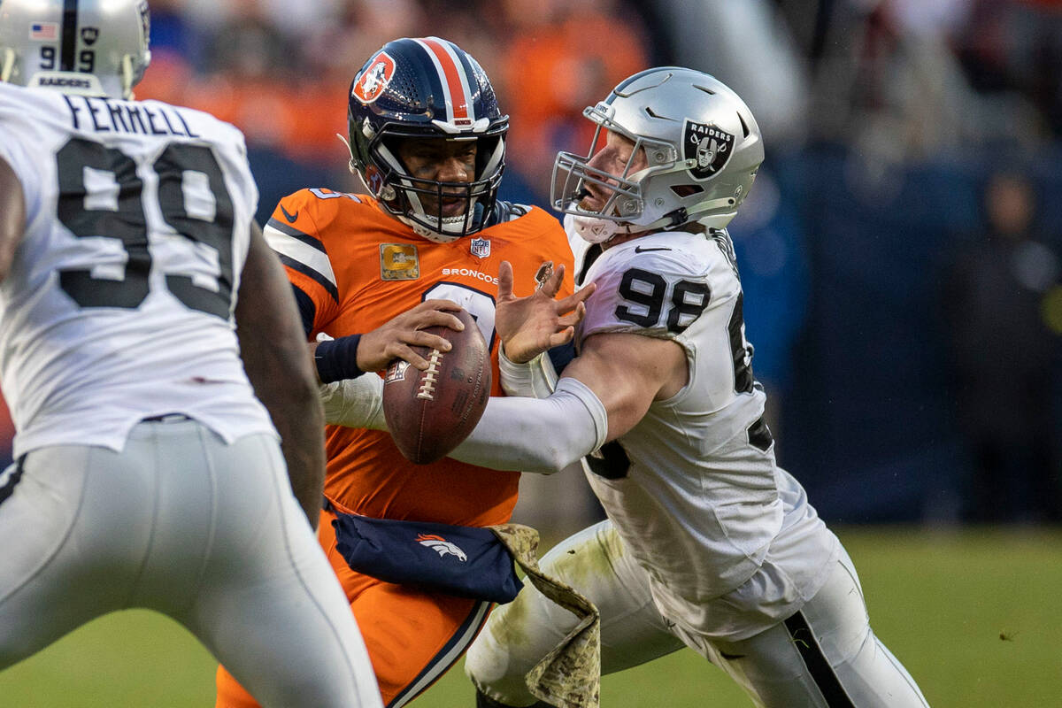 Raiders defensive end Maxx Crosby (98) sacks Denver Broncos quarterback Russell Wilson (3) duri ...