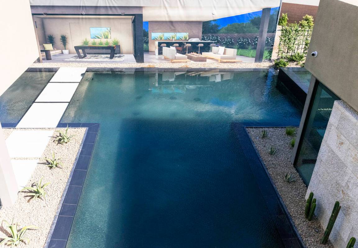 The swimming pool is seen outside the newly finished house at the Oasi homes, built by Blue Her ...