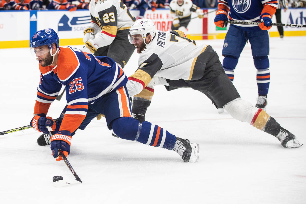 Vegas Golden Knights' Alex Pietrangelo (7) trips Edmonton Oilers' Darnell Nurse (25) during the ...