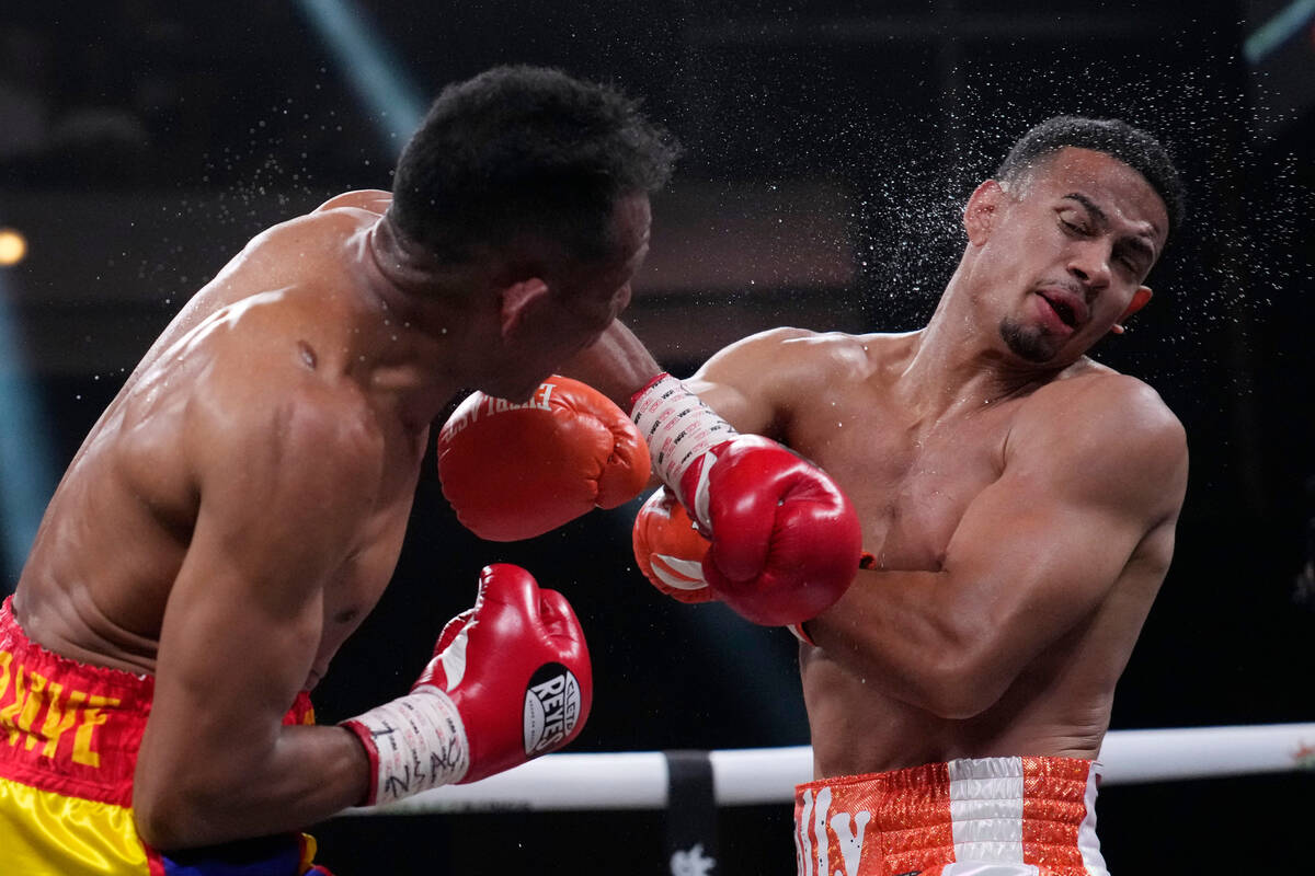 Ismael Barroso, left, punches Rolando Romero in a super lightweight title boxing match Saturday ...