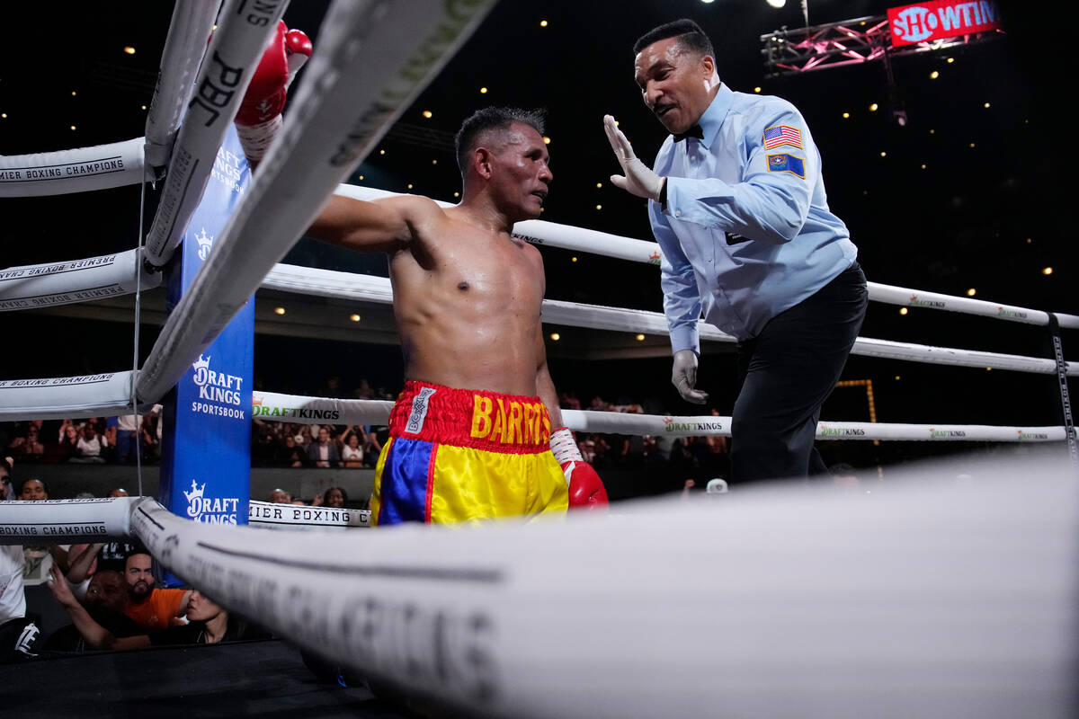 Ismael Barroso kneels on the mat after he was knocked down by Rolando Romero in a super lightwe ...