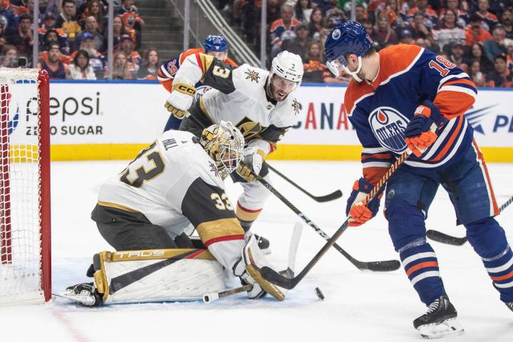 Vegas Golden Knights goalie Adin Hill (33) makes the save on Edmonton Oilers' Zach Hyman (18) a ...