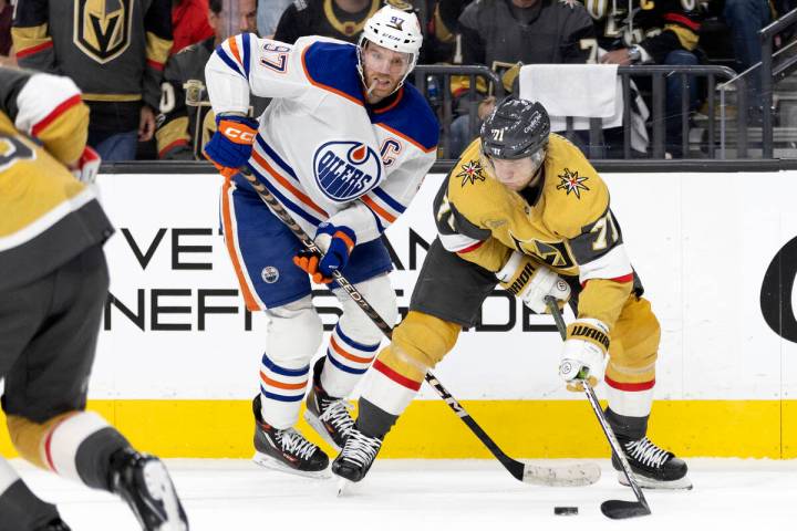 Golden Knights center William Karlsson (71) maneuvers the puck from Edmonton Oilers center Conn ...