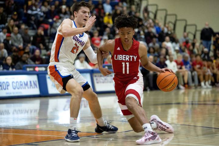 Liberty’s Dedan Thomas Jr. (11) dribbles around Bishop Gorman’s Ryder Elisaldez ( ...