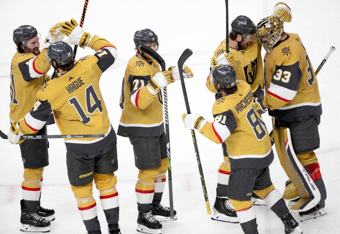 The Golden Knights line up to congratulate goaltender Adin Hill (33) after they won Game 5 of a ...