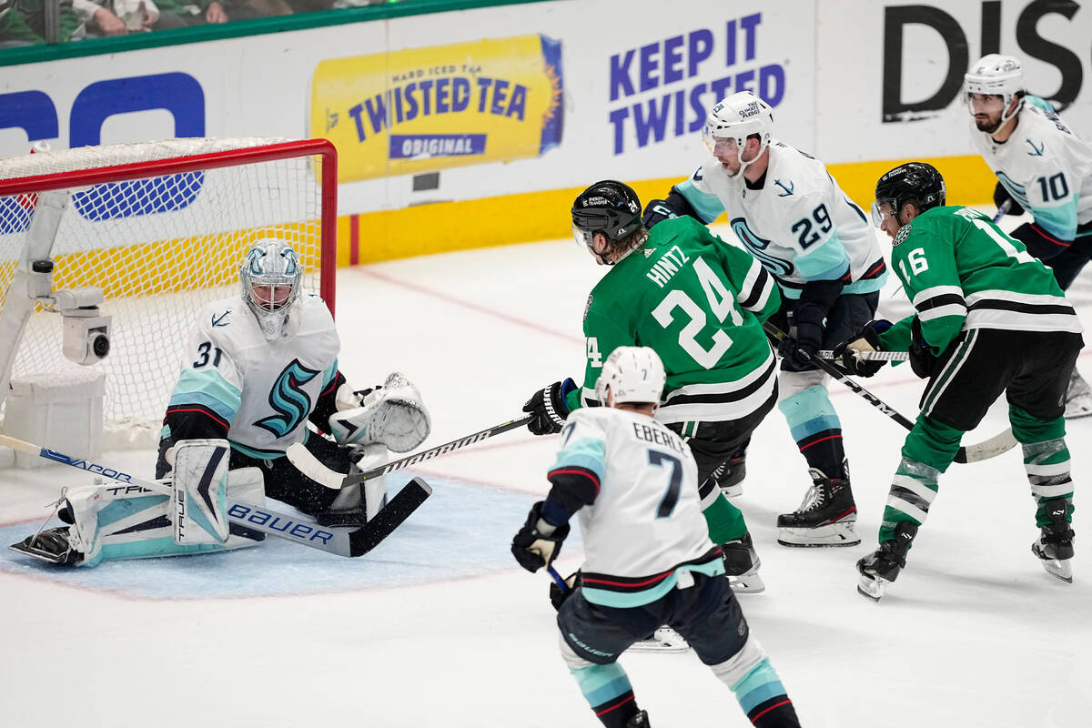 Dallas Stars center Roope Hintz (24) scores against Seattle Kraken goaltender Philipp Grubauer ...