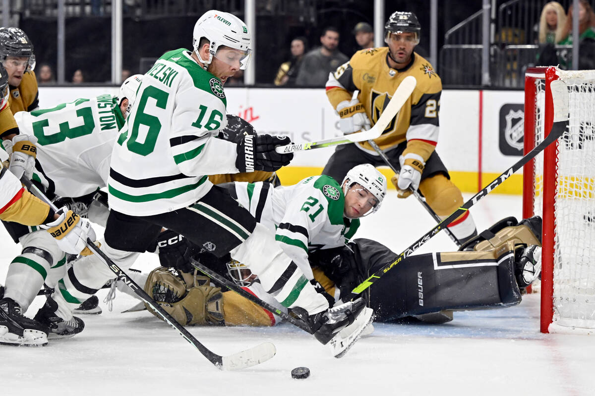 Dallas Stars center Joe Pavelski (16) and left wing Jason Robertson (21) pressure Vegas Golden ...