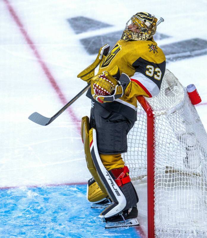 Golden Knights goaltender Adin Hill (33) leans back on the net during a face-off break against ...