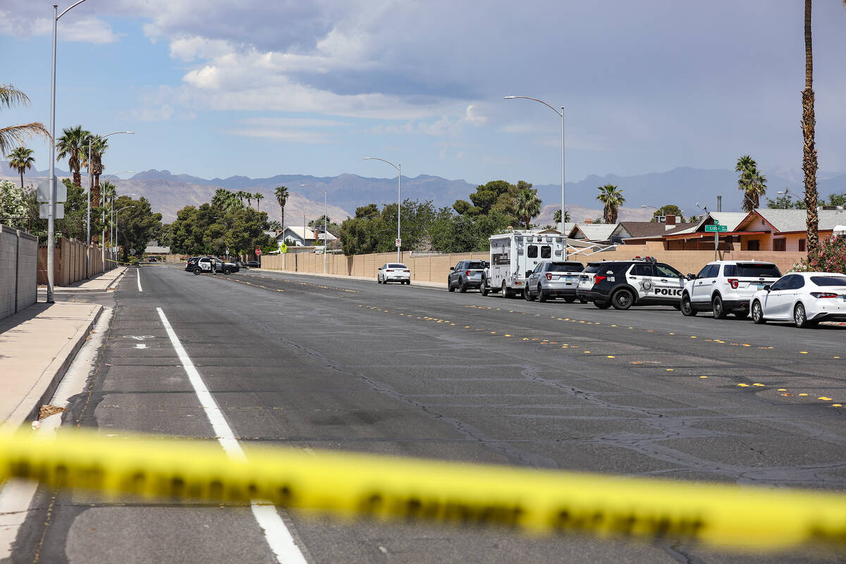 Police at the scene where three people were shot, including one fatally, in southwest Las Vegas ...