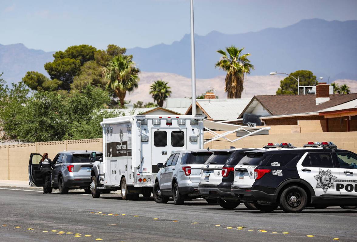 Police at the scene where three people were shot, including one fatally, in southwest Las Vegas ...