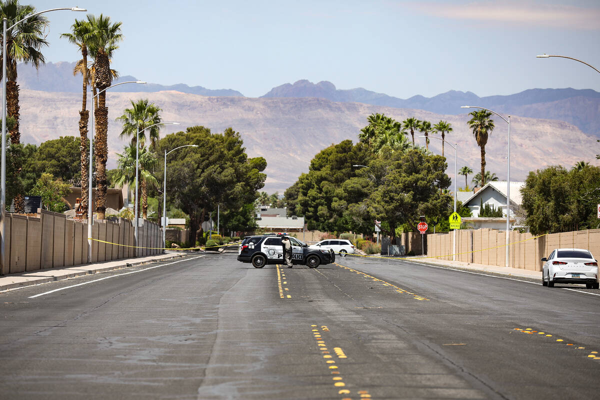 Police at the scene where three people were shot, including one fatally, in southwest Las Vegas ...