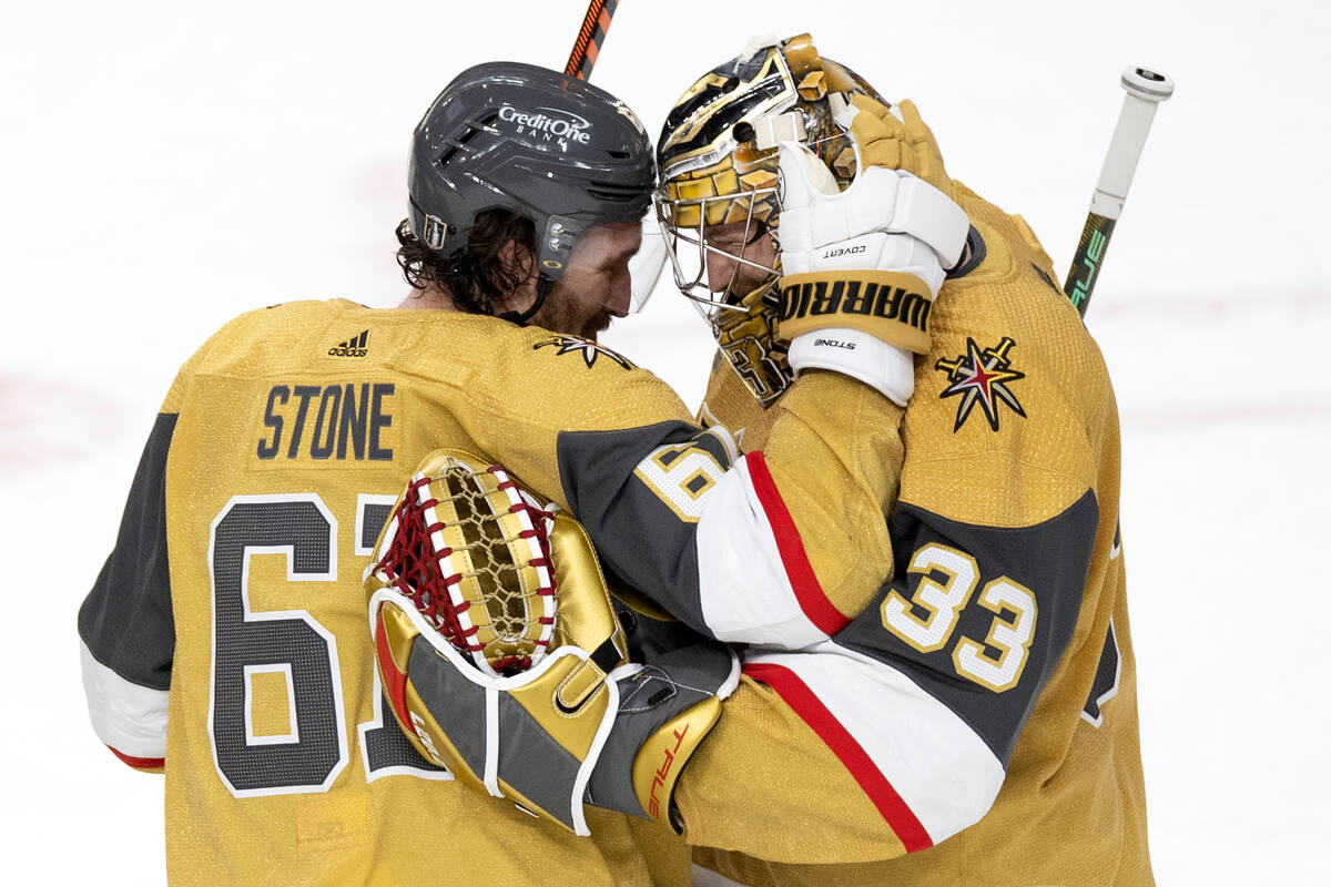 Golden Knights right wing and captain Mark Stone (61) congratulates goaltender Adin Hill (33) a ...