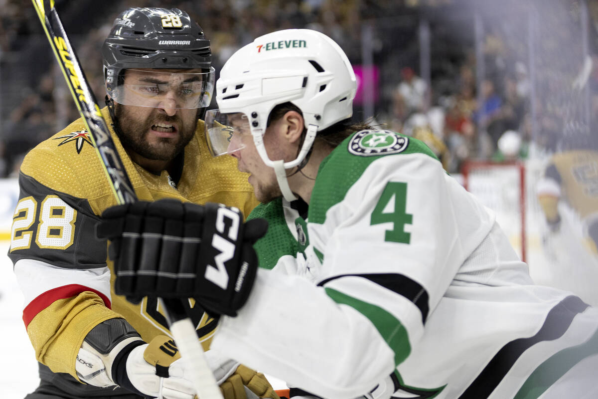 Golden Knights left wing William Carrier (28) defends against Dallas Stars defenseman Miro Heis ...