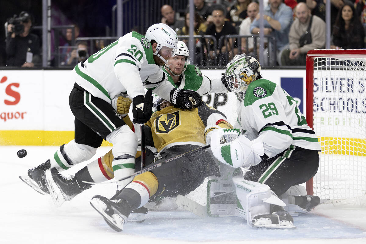 Golden Knights right wing Keegan Kolesar (55) falls into the net after Dallas Stars goaltender ...