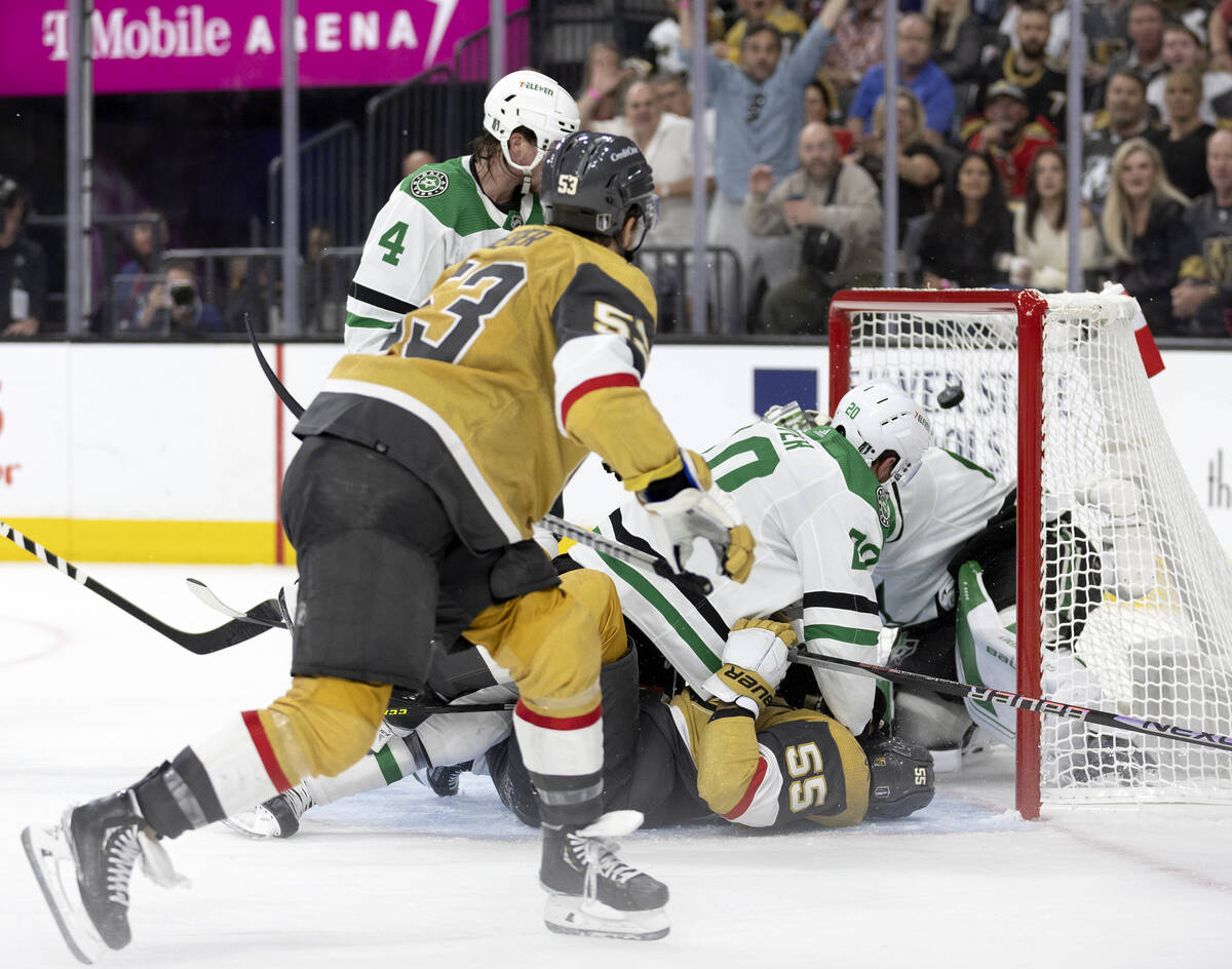 Golden Knights center Teddy Blueger (53) scores on Dallas Stars goaltender Jake Oettinger (29) ...