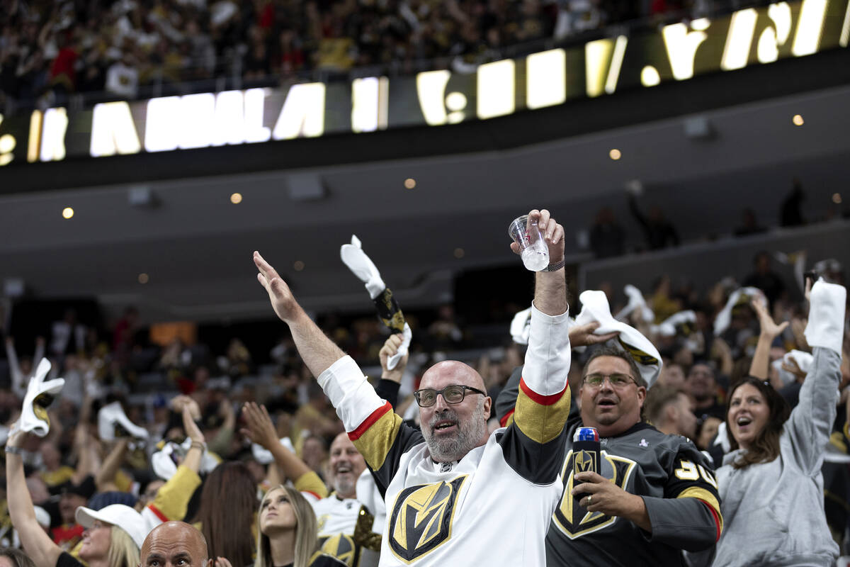 Golden Knights fans celebrate after Knights center Brett Howden (21) scored the game-winning go ...