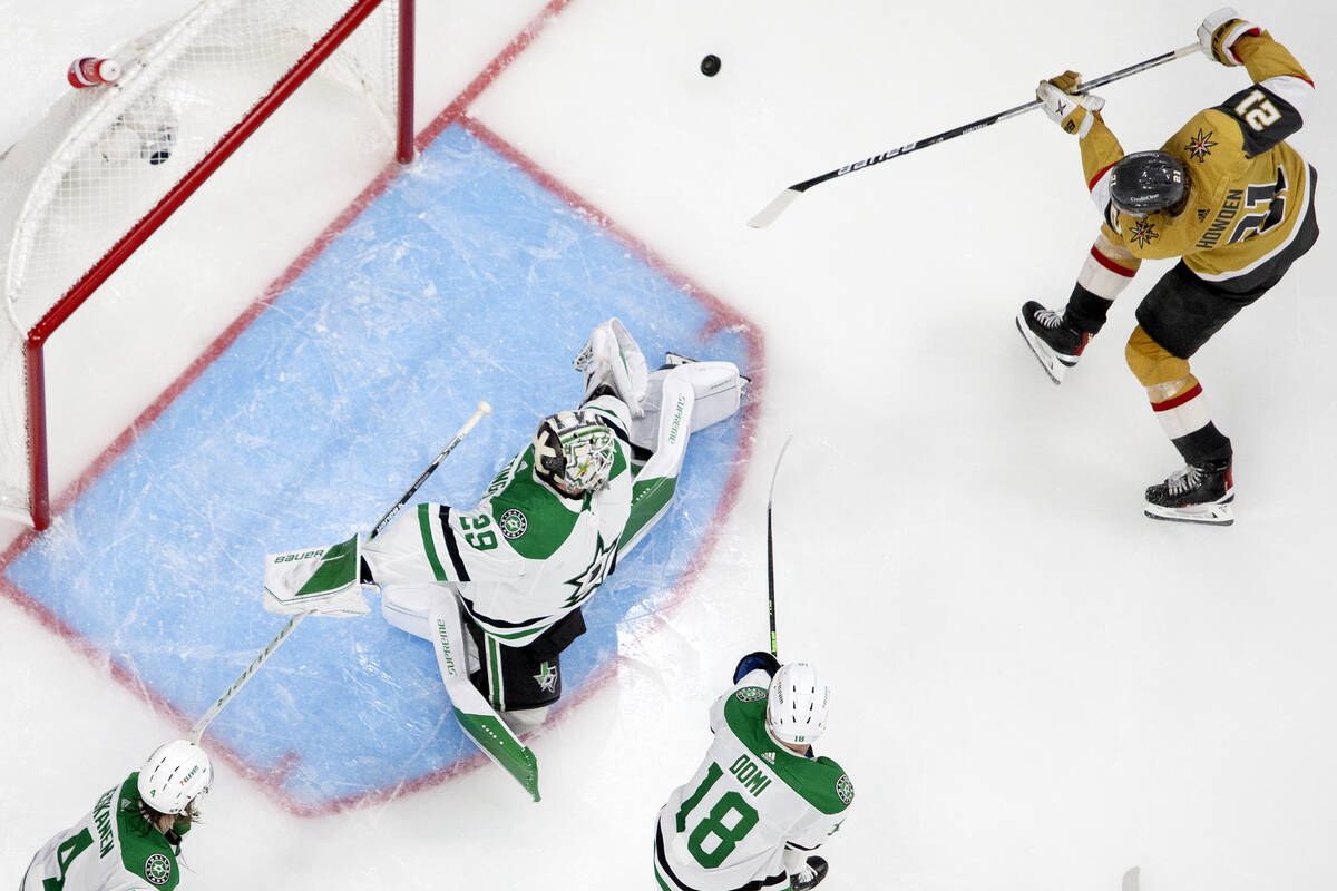 Golden Knights center Brett Howden (21) misses the net while Dallas Stars goaltender Jake Oetti ...