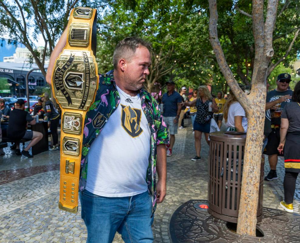 Golden Knights fan Paul Prunier shows off his championship belt outside before the first period ...