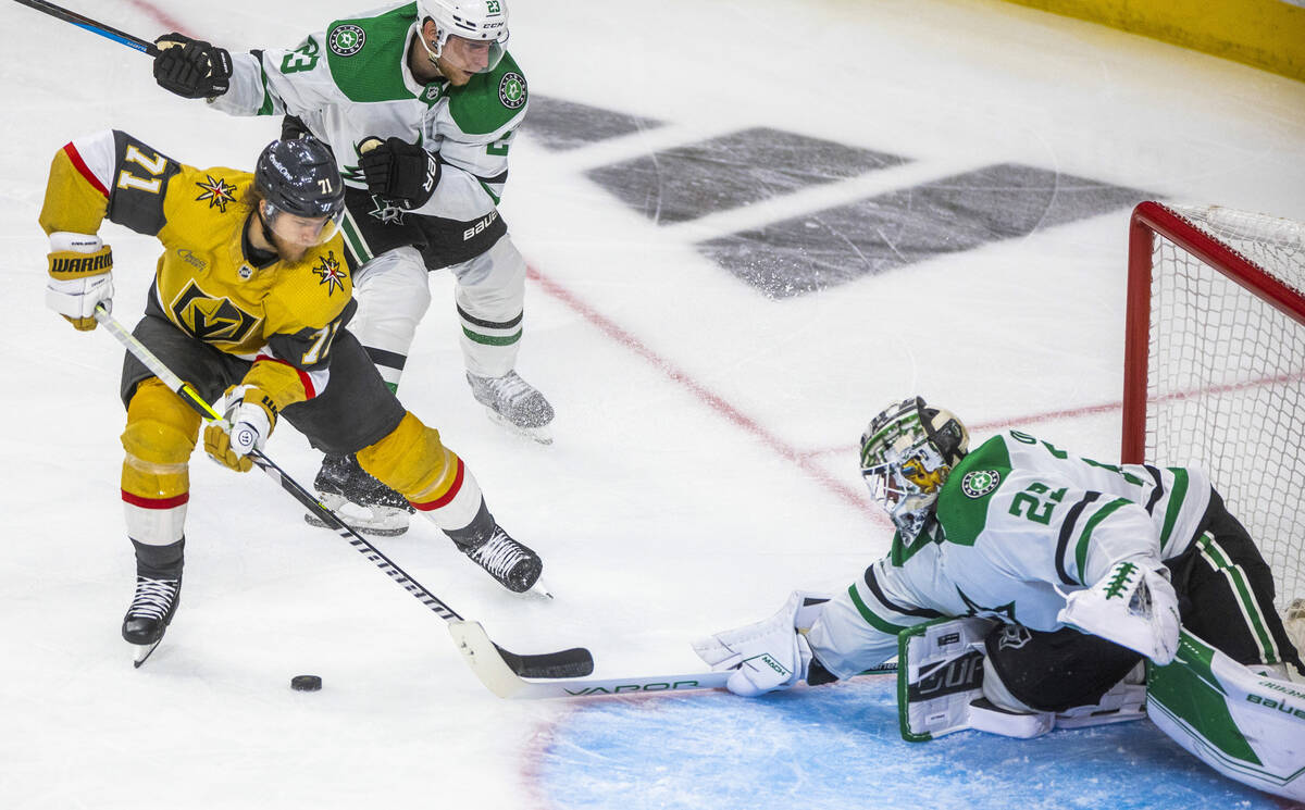 Golden Knights center William Karlsson (71) eyes the goal as he is defended by Dallas Stars goa ...