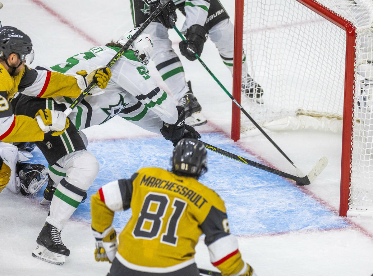 Dallas Stars defenseman Thomas Harley (55) stops the ouck at the goal line as the Golden Knight ...