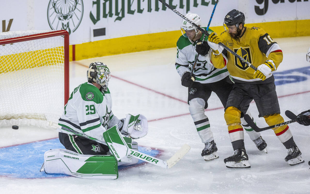 Golden Knights center Nicolas Roy (10) and Dallas Stars defenseman Esa Lindell (23) watch the p ...