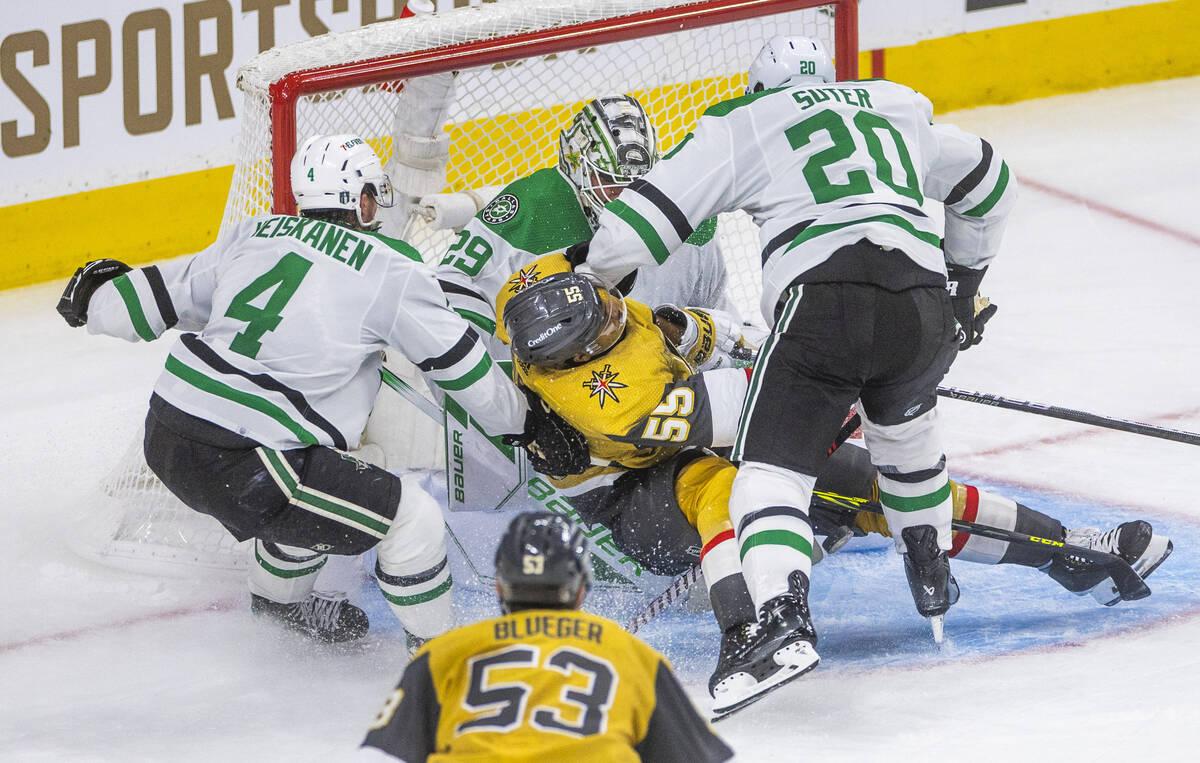 Golden Knights right wing Keegan Kolesar (55) is hammered down while driving the puck deep in t ...