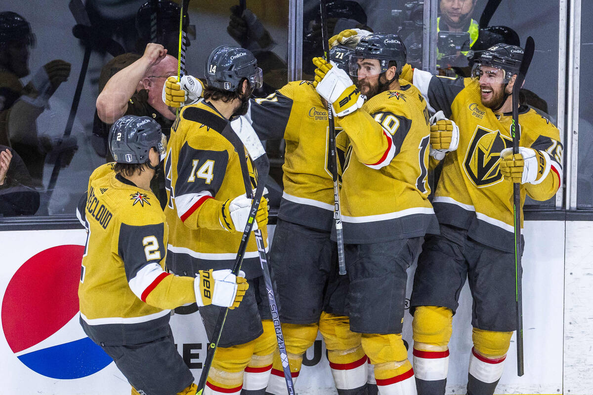 Teammates swarm Golden Knights center William Karlsson (71) after a score against Dallas Stars ...