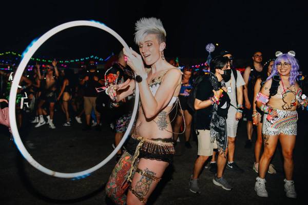 Billie Peterson, left, dances with a hula hoop during the first day of Electric Daisy Carnival ...
