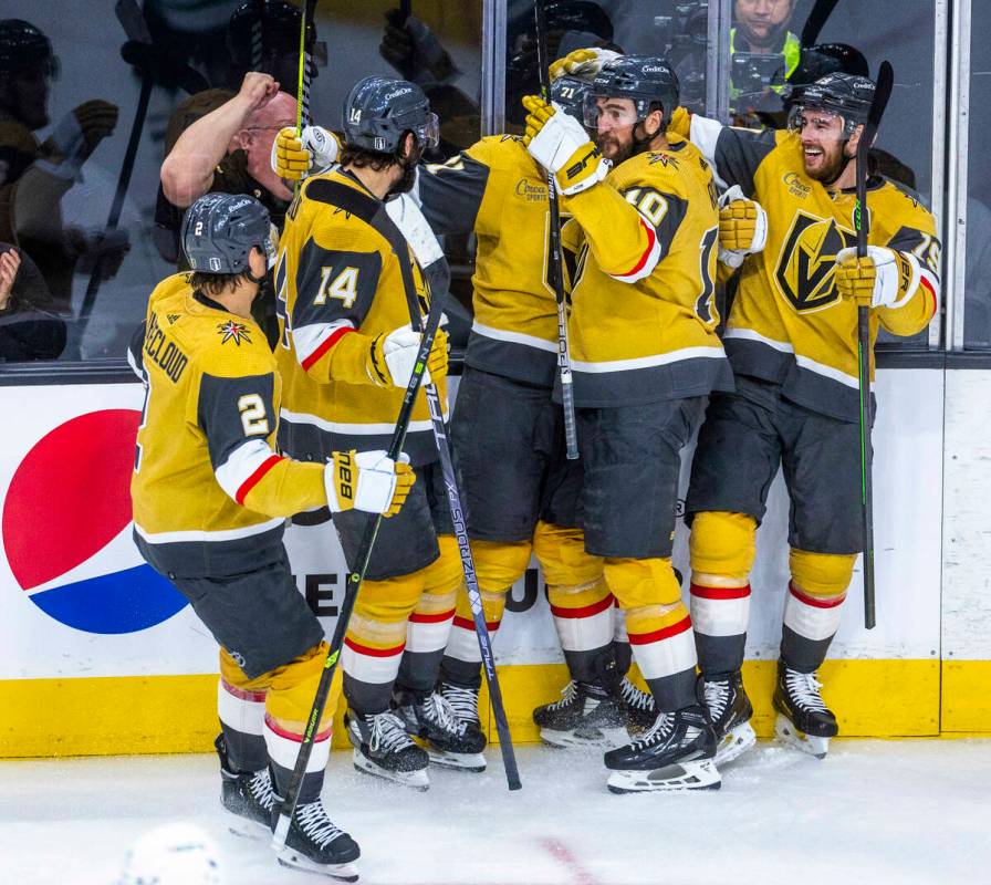 Teammates swarm Golden Knights center William Karlsson (71) after a score against Dallas Stars ...