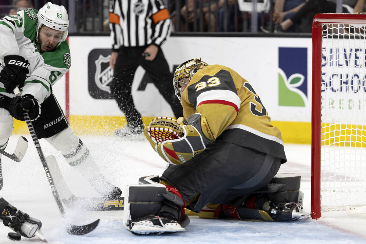 Golden Knights goaltender Adin Hill (33) saves the puck against Dallas Stars right wing Evgenii ...