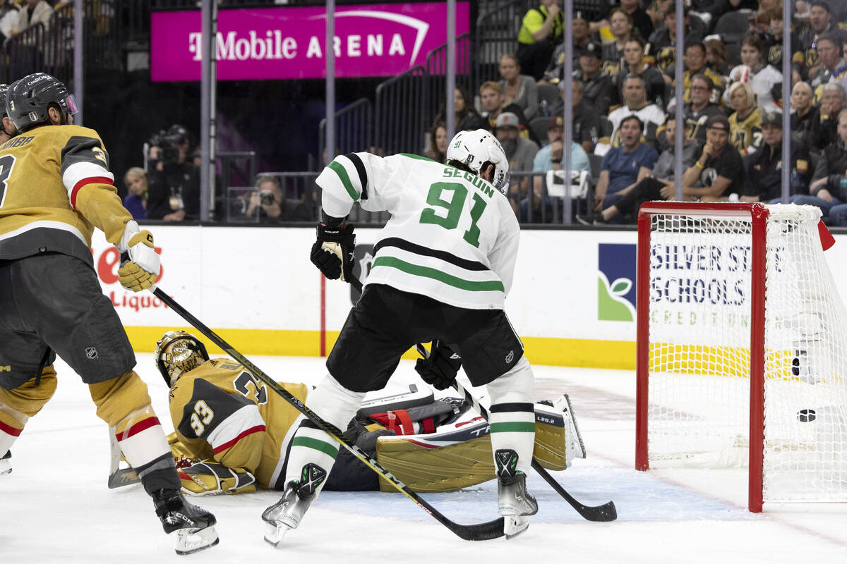 Golden Knights goaltender Adin Hill (33) dives but misses the save on Dallas Stars left wing Ja ...