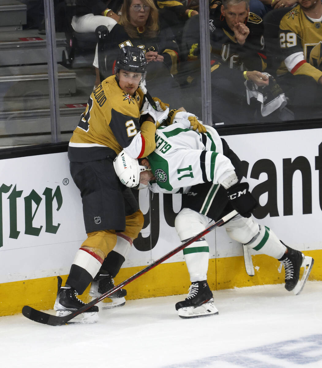 Golden Knights defenseman Zach Whitecloud (2) tangles with and Dallas Stars center Luke Glenden ...