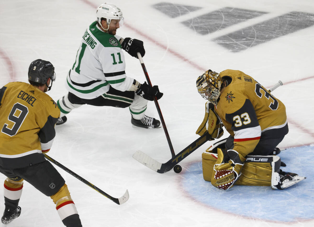 Golden Knights goaltender Adin Hill (33) makes a save against Dallas Stars center Luke Glendeni ...