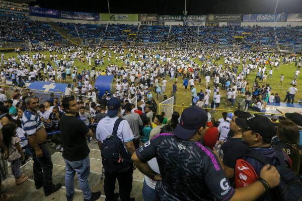 Fans take to the field of Cuscatlan stadium in San Salvador, El Salvador, Saturday, May 20, 202 ...