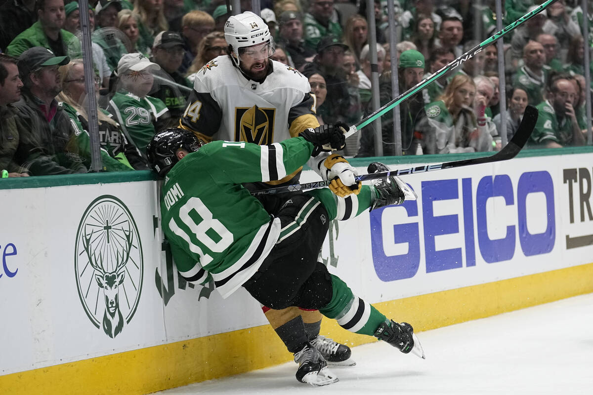 Dallas Stars center Max Domi (18) and Vegas Golden Knights defenseman Nicolas Hague (14) collid ...