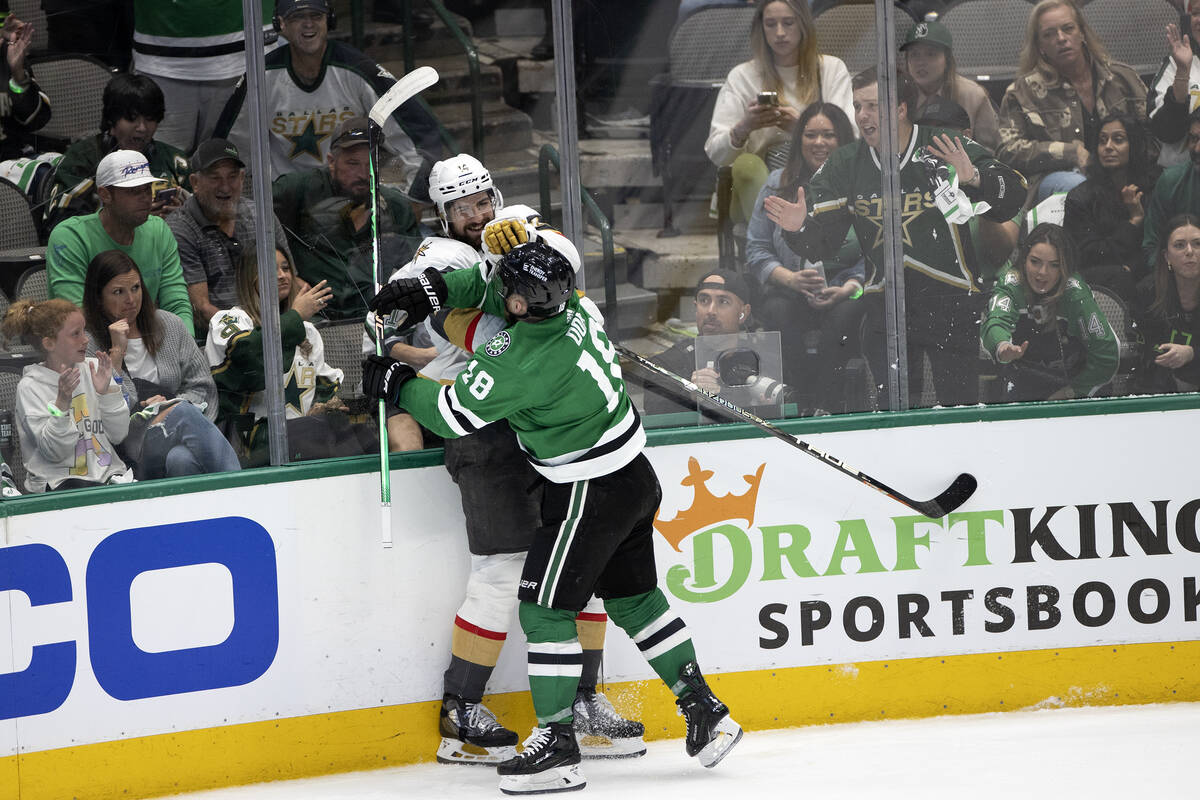 Golden Knights defenseman Nicolas Hague (14) and Dallas Stars center Max Domi (18) fight during ...