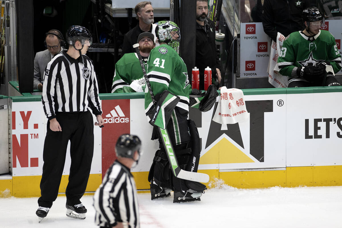 Dallas Stars goaltenders Jake Oettinger, center left, and Scott Wedgewood (41) break from play ...