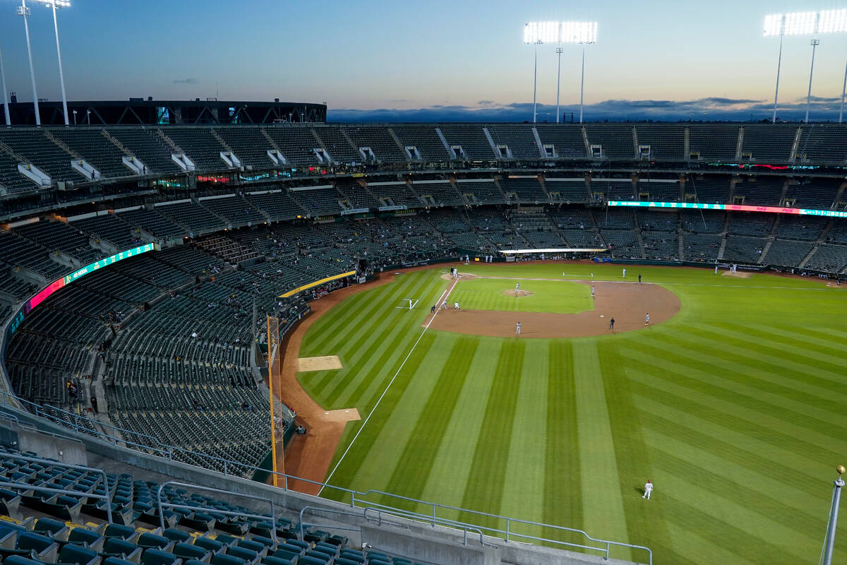 Fans watch a baseball game between the Oakland Athletics and the Arizona Diamondbacks in Oaklan ...