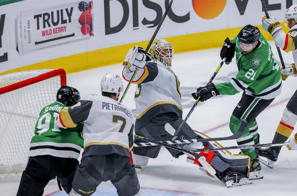 Dallas Stars left wing Jason Robertson (21) scores against Vegas Golden Knights goalie Adin Hil ...