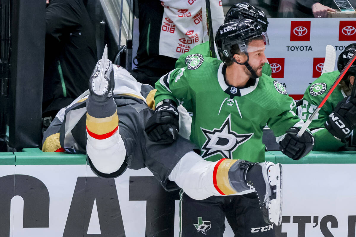 Dallas Stars' Luke Glendening, right, checks Vegas Golden Knights Alex Pietrangelo atop the boa ...