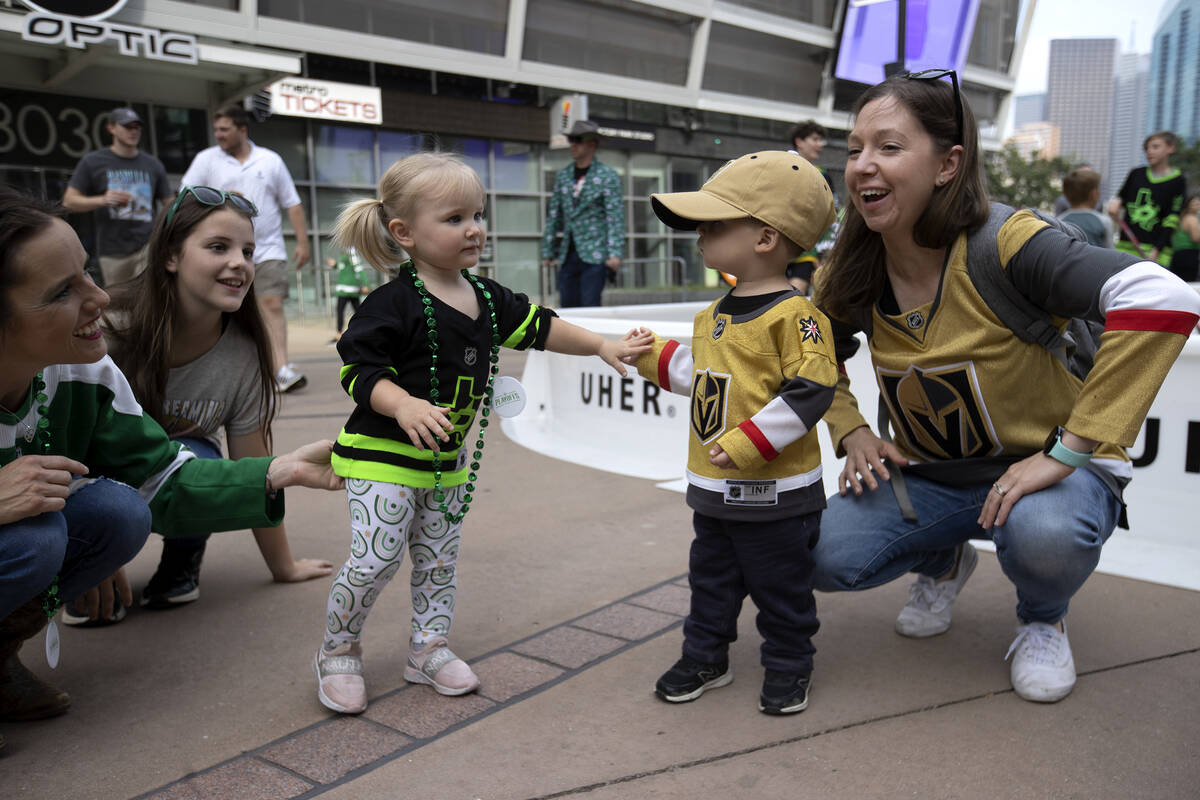 Dallas Stars fan Brooklyn House-Pokrzywa, 1, center left, slaps hands Golden Knights fan Luca L ...