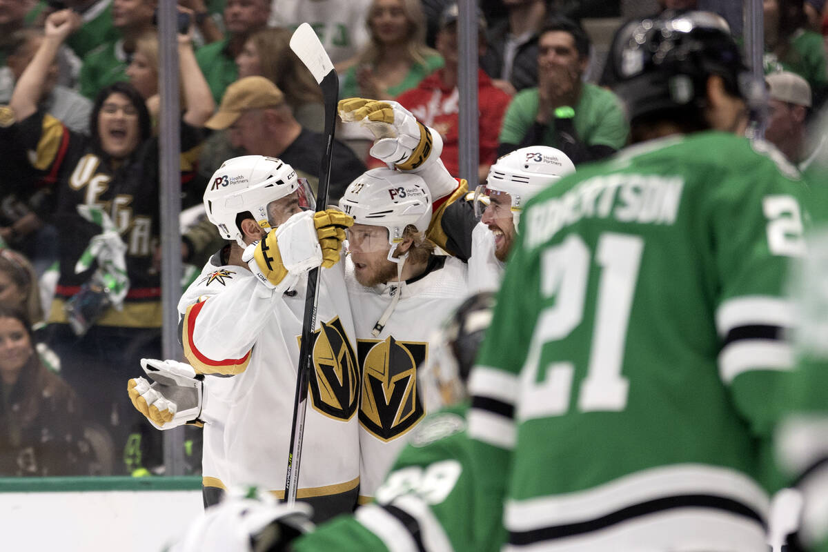 Golden Knights center William Karlsson, center, is surround by Golden Knights' Nicolas Roy, lef ...