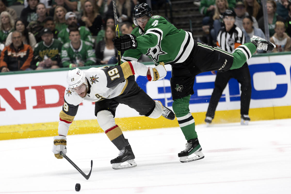 Golden Knights right wing Reilly Smith (19) and Dallas Stars defenseman Miro Heiskanen (4) tang ...