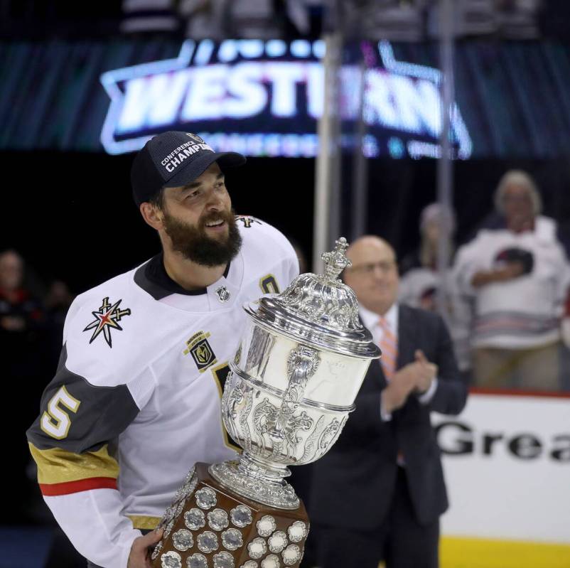 Vegas Golden Knights' Deryk Engelland (5) accepts the Clarence S. Campbell Bowl from Deputy Com ...