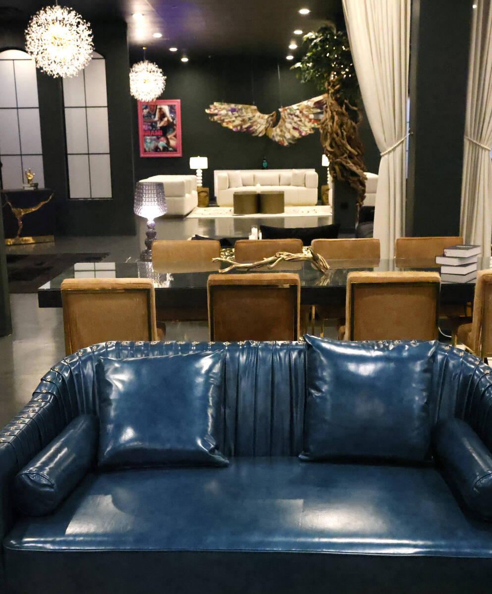 Dining table and a leather sofa is displayed at Sanctuary Furniture, on Thursday, May 25, 2023, ...